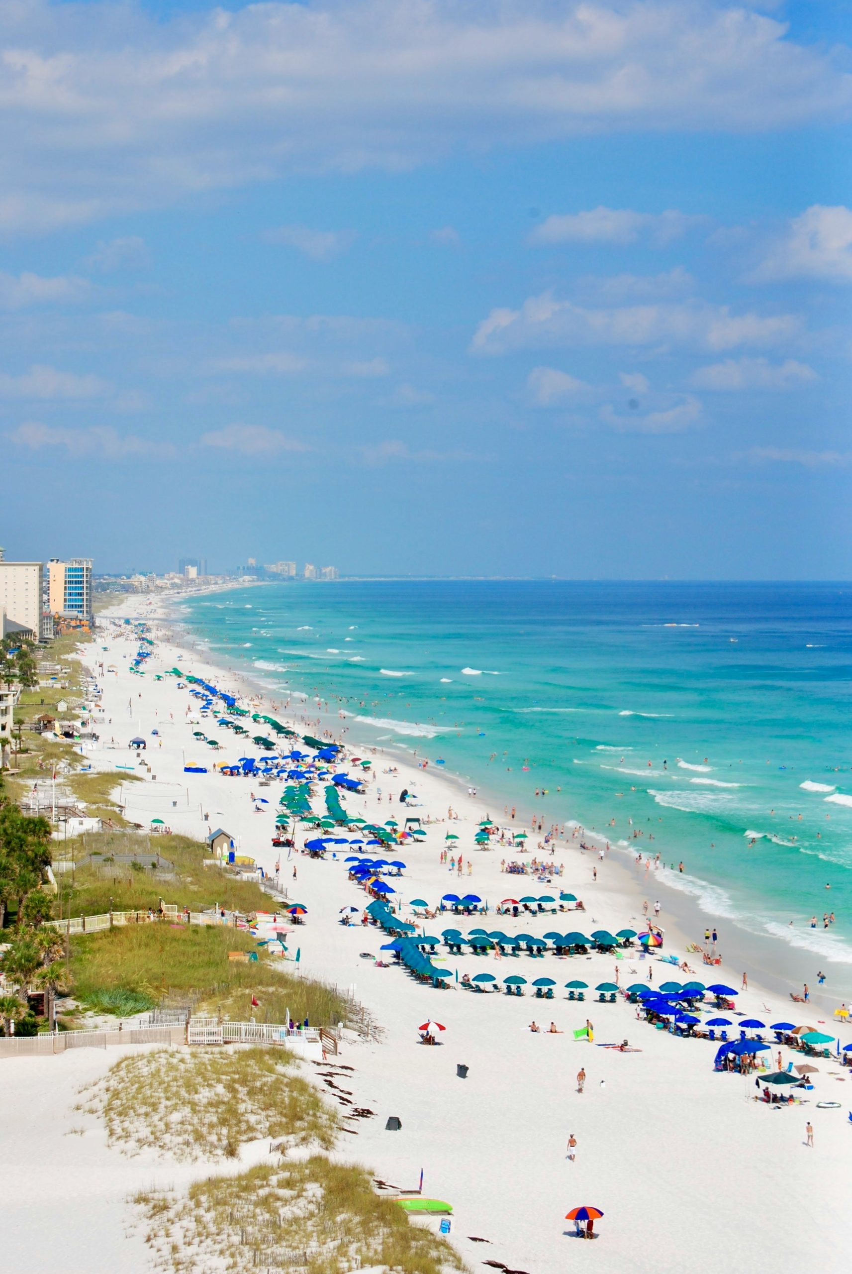 Aerial view of a busy white-sand beach and turquoise ocean – Delray Beach vs Boca Raton